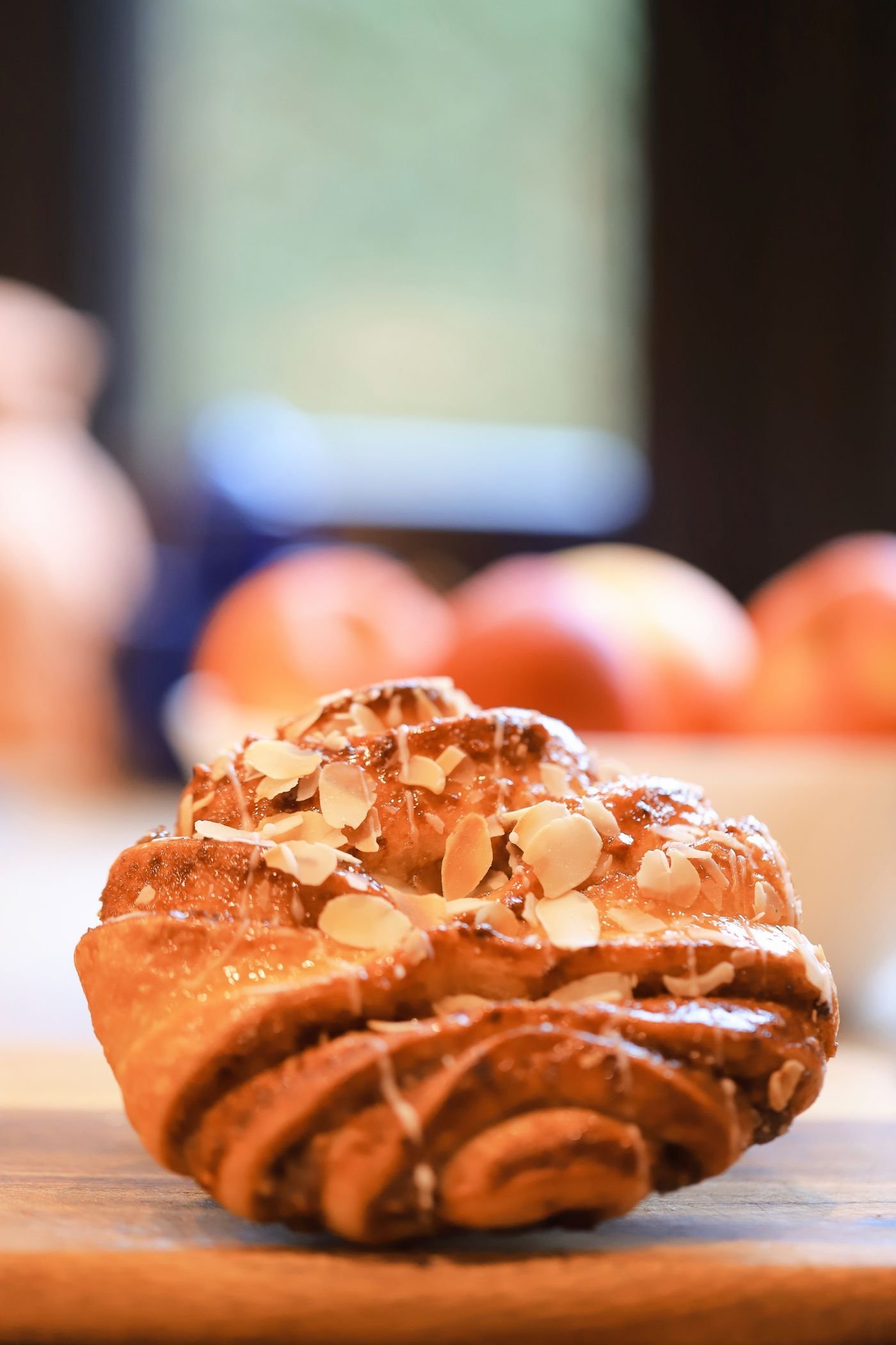 A flaky almond pastry on a wooden board