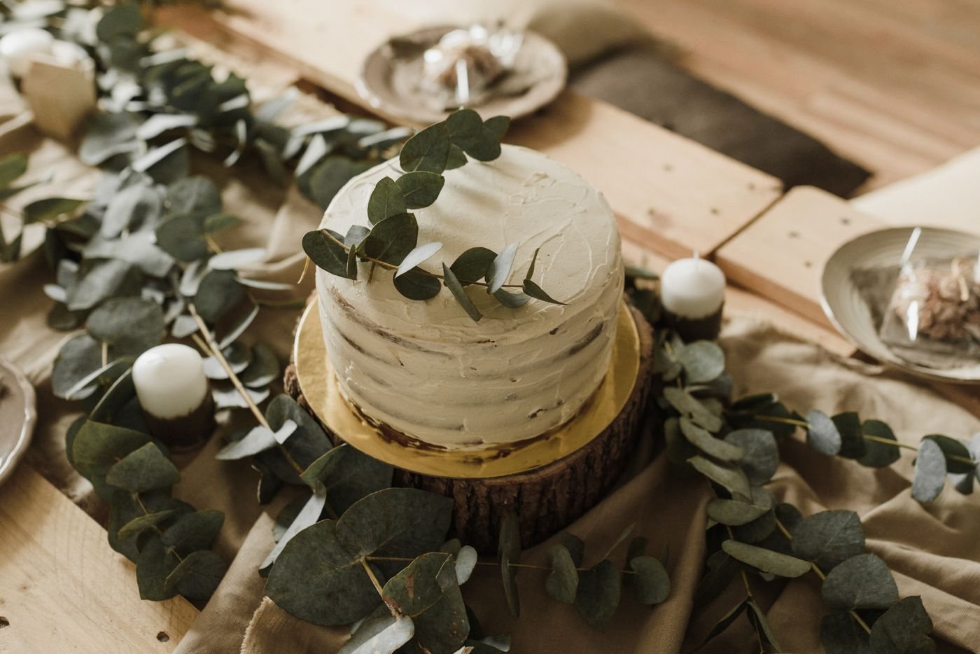 A naked cake decorated with eucalyptus