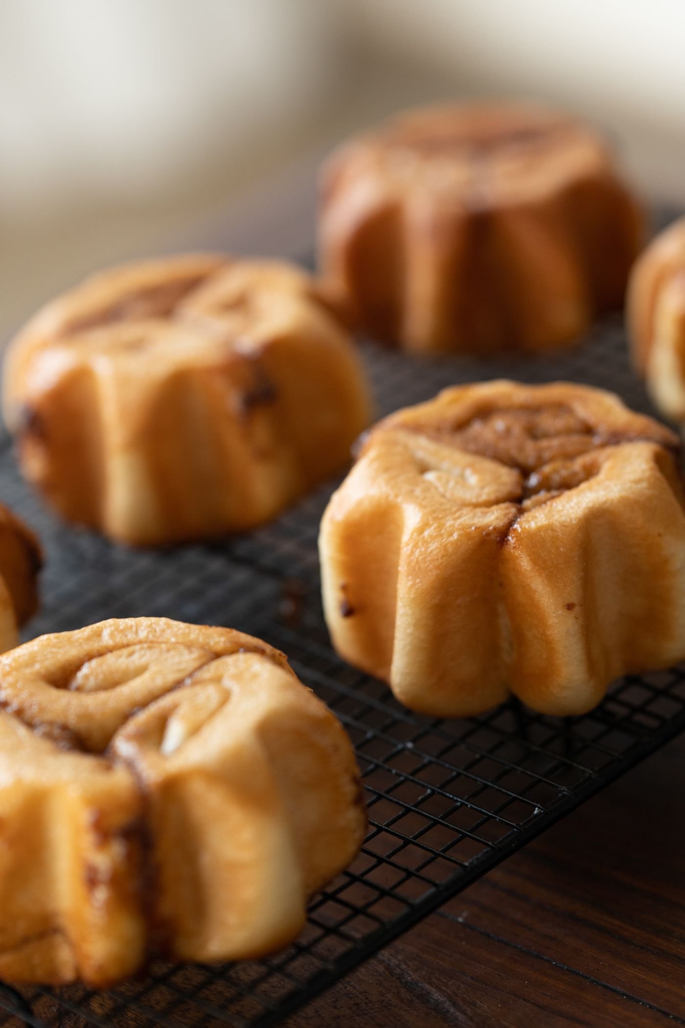 Cinnamon buns cooling on a wire rack